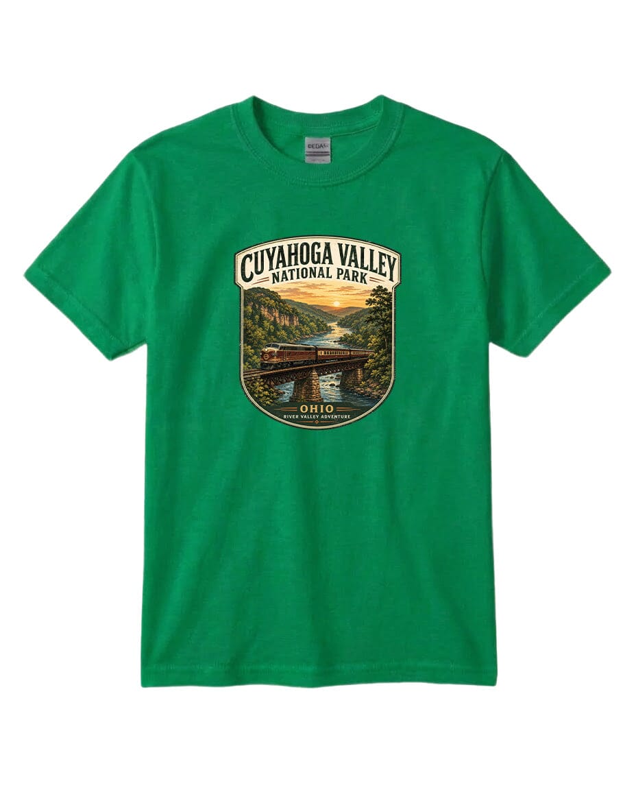A green t-shirt with a graphic design depicting a scenic view of the Cuyaohoga Valley National Park, featuring a bridge, trees, and a sunset over a river.
