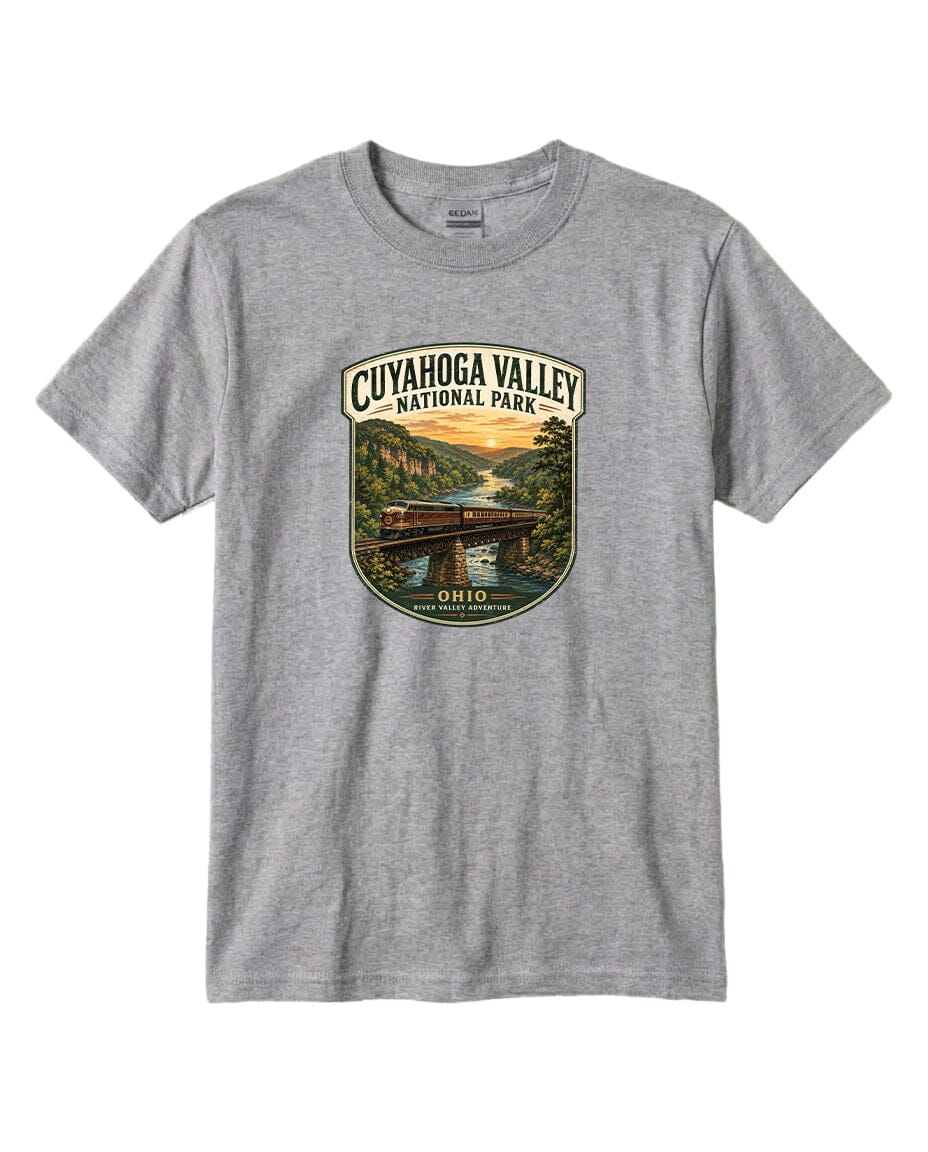 A gray t-shirt with a graphic design depicting a scenic view of the Cuyahoga Valley National Park, featuring a bridge, a river, and a sunset landscape.