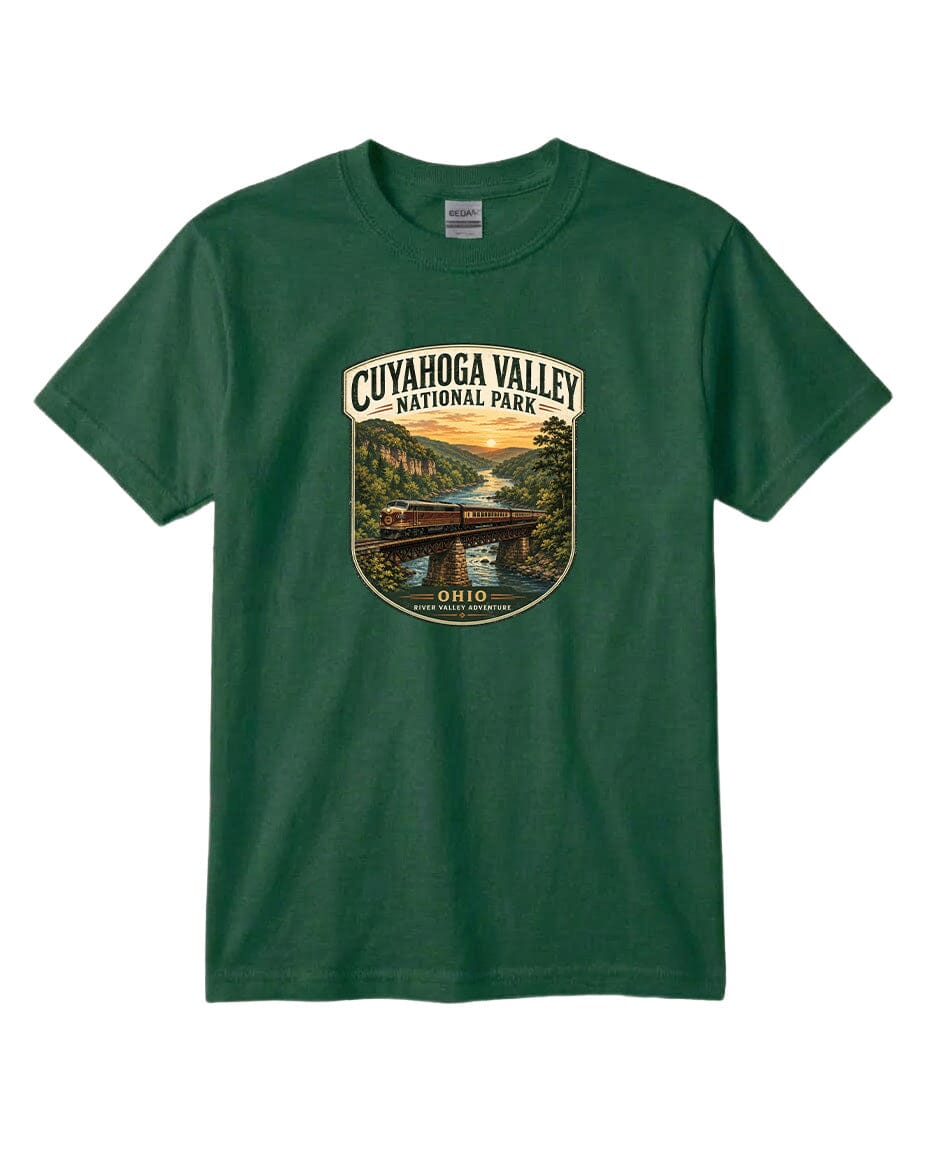 A green t-shirt with a graphic design depicting a scenic view of the Cuyahoga Valley National Park, featuring a bridge, river, and sunset landscape.
