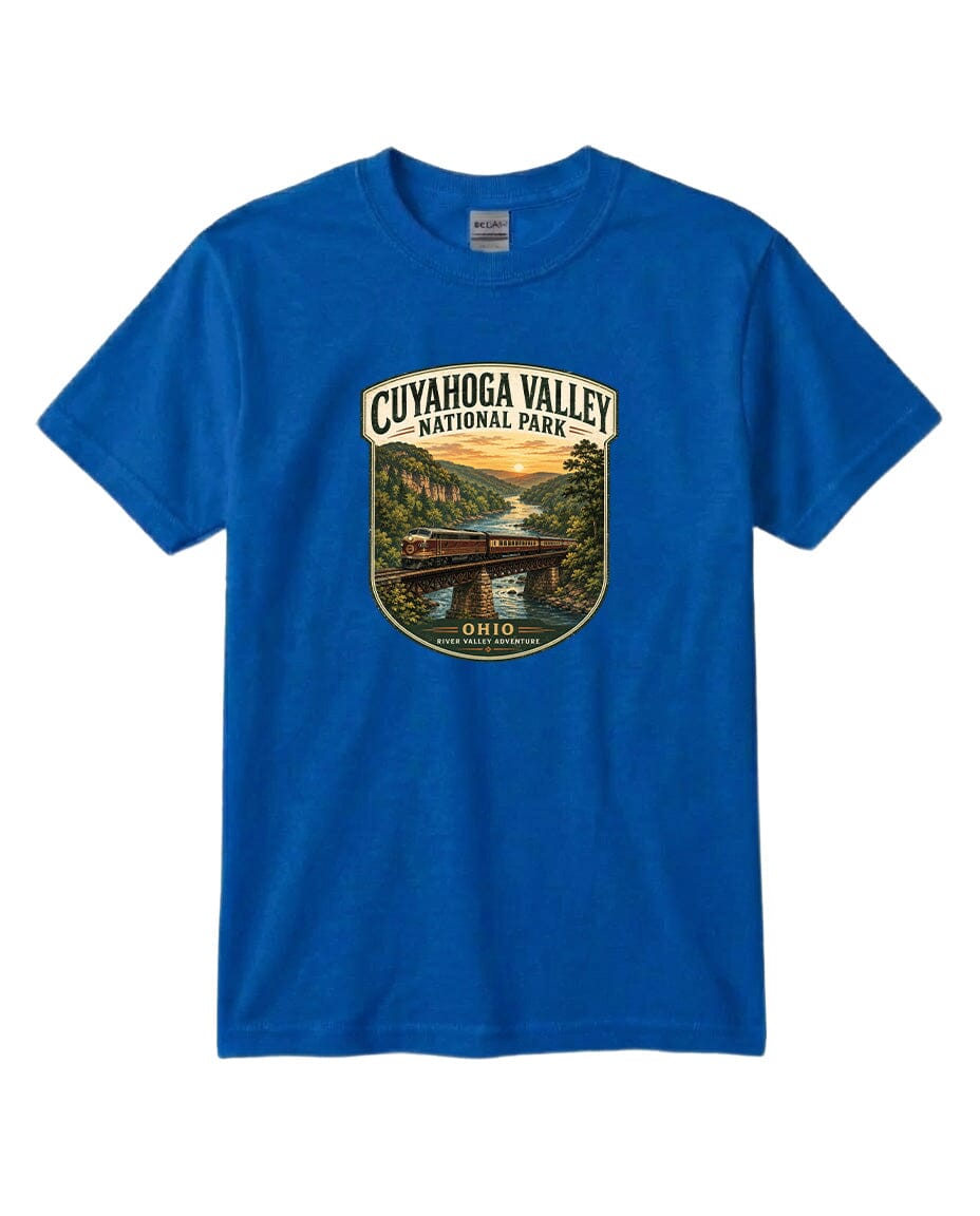 A blue t-shirt with a graphic design depicting a scenic view of the Cuyahoga Valley National Park, featuring a bridge, trees, and a sunset.