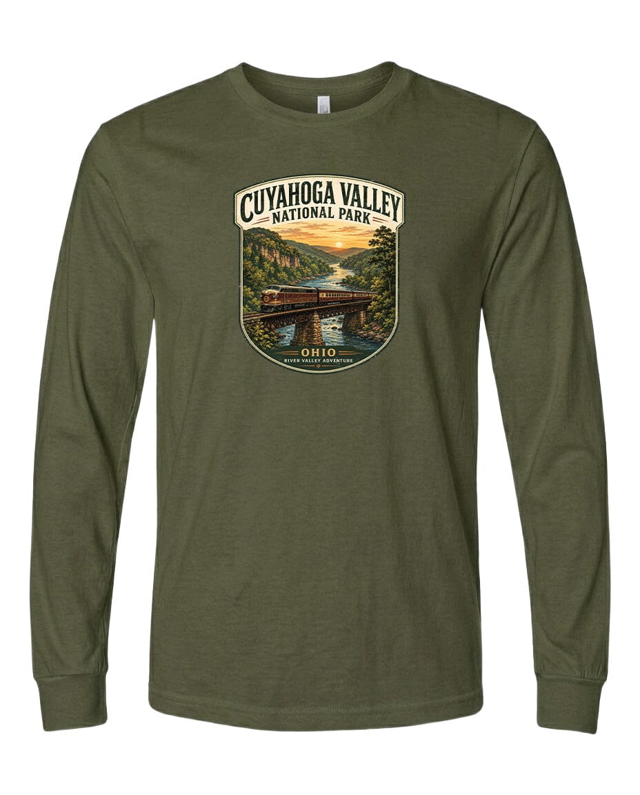 A long-sleeved olive green t-shirt with a graphic design depicting a scenic view of the Cuyahoga Valley National Park, featuring a bridge, trees, and a sunset.