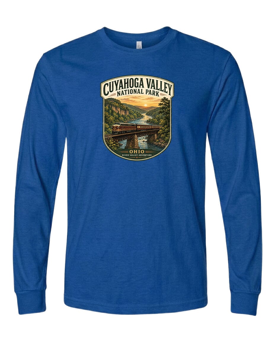 A blue long-sleeved t-shirt with a graphic design depicting a scenic view of the Cuyaohoga Valley National Park, featuring a bridge, trees, and a sunset.