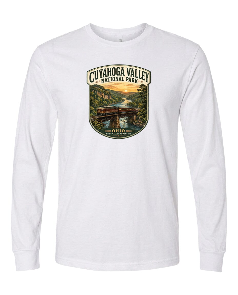 A white long-sleeved t-shirt with a graphic design depicting a scenic view of the Cuyahoga Valley National Park, featuring a bridge, trees, and a sunset.