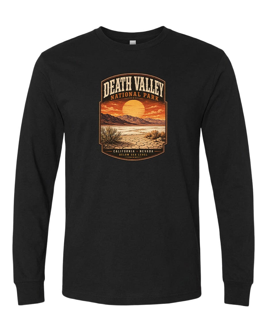 A black long-sleeve t-shirt with a graphic design depicting a desert landscape with a sunset in the background.