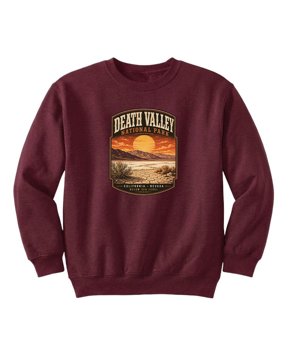A burgundy sweatshirt with a graphic design depicting a sunset over Death Valley National Park, California, Nevada.