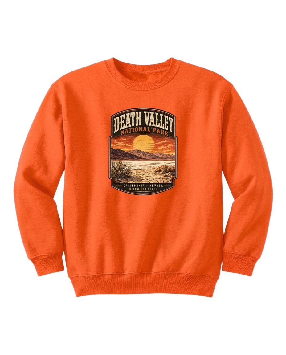 An orange sweatshirt with a graphic design depicting a sunset over Death Valley National Park.