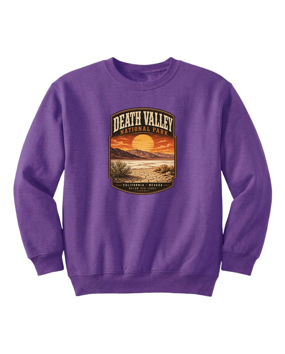 A purple sweatshirt with a graphic design depicting a sunset over Death Valley National Park.