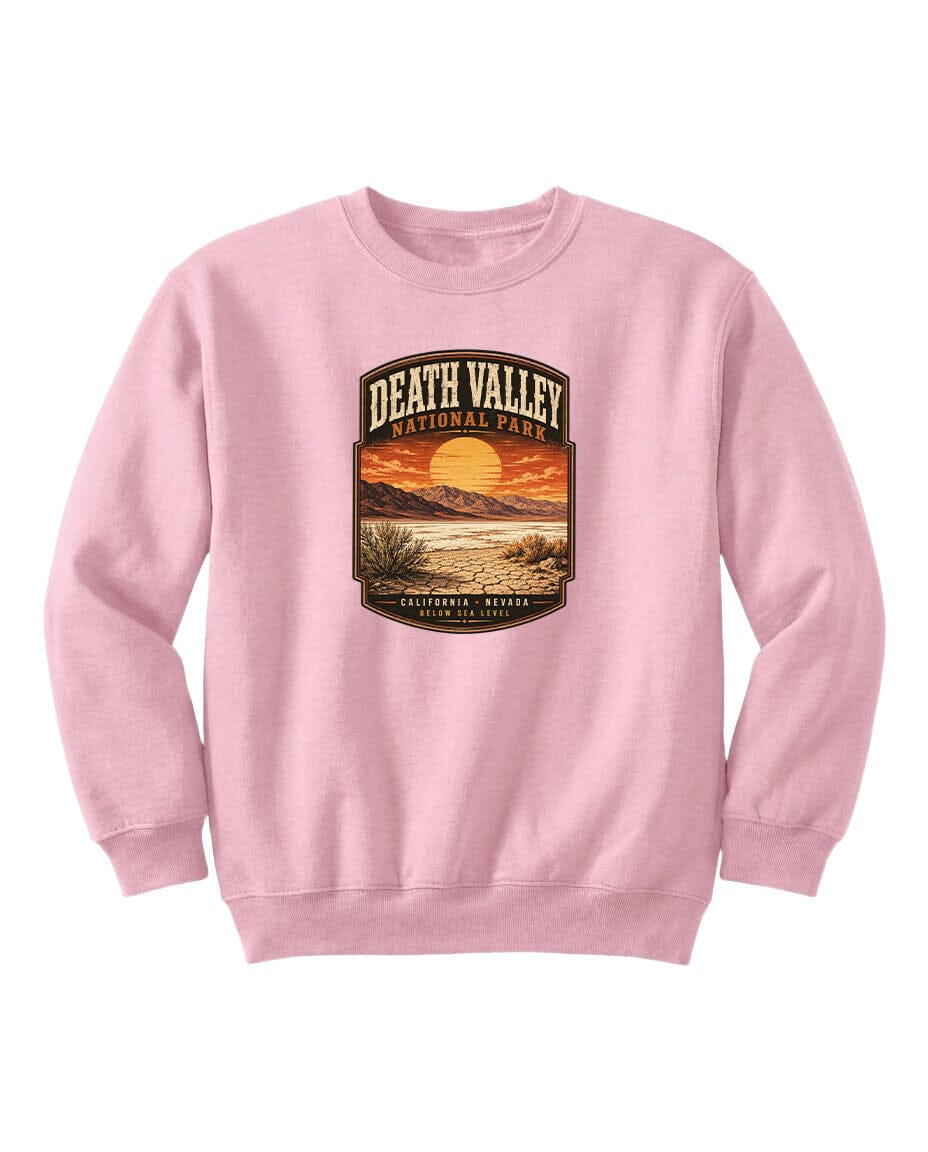 A pink sweatshirt with a graphic design depicting a sunset over Death Valley National Park.