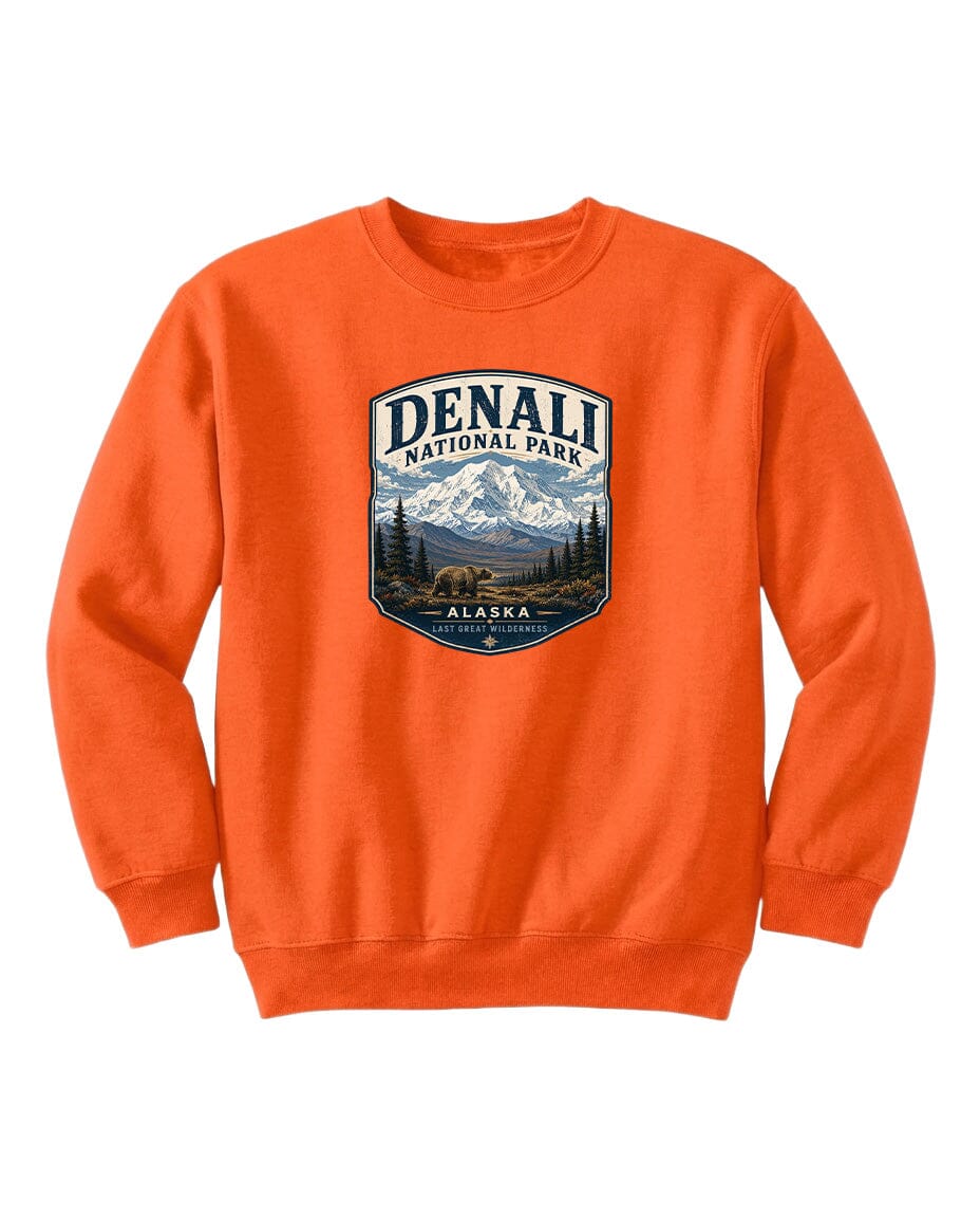 An orange sweatshirt with a graphic design featuring a mountain landscape and bears, representing Denali National Park in Alaska.