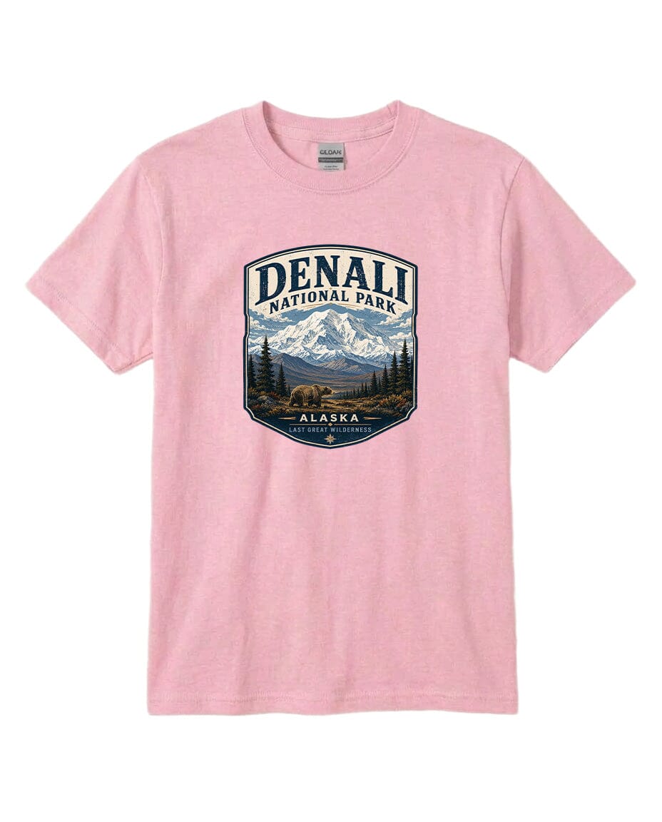 A pink t-shirt with a graphic design depicting a mountain landscape with a bear, surrounded by text that says "DENALI NATIONAL PARK ALASKA LAST GREATNESS".