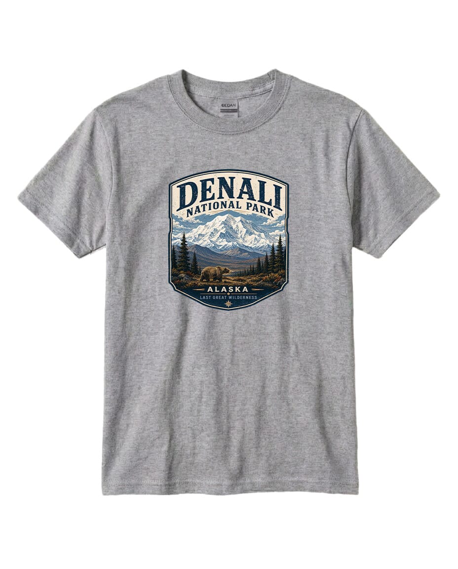 A gray t-shirt with a graphic design featuring a mountain landscape and the text "DENALI NATIONAL PARK ALASKA LAST GREAT WILDERNESS".