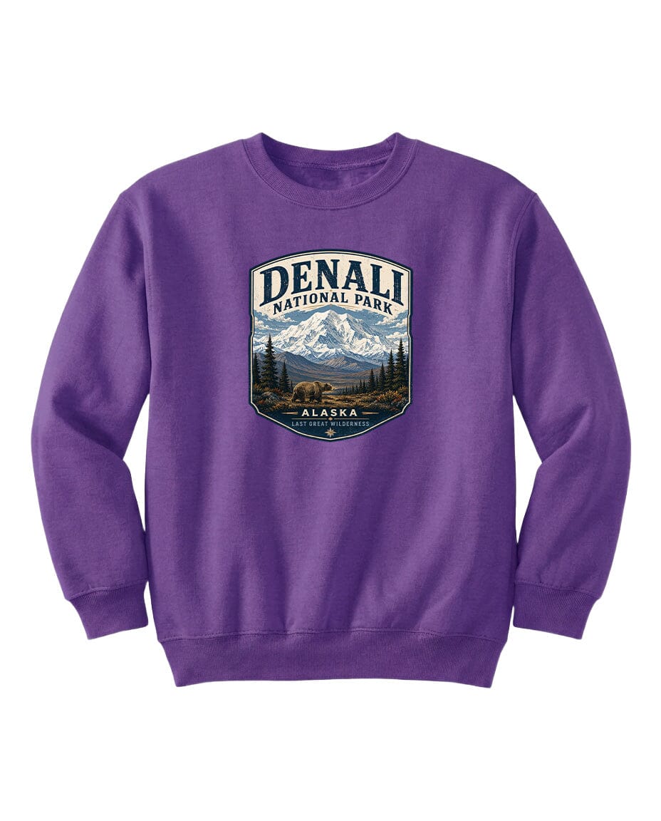 A purple sweatshirt with a graphic design featuring a mountain landscape and bears, representing Denali National Park in Alaska.