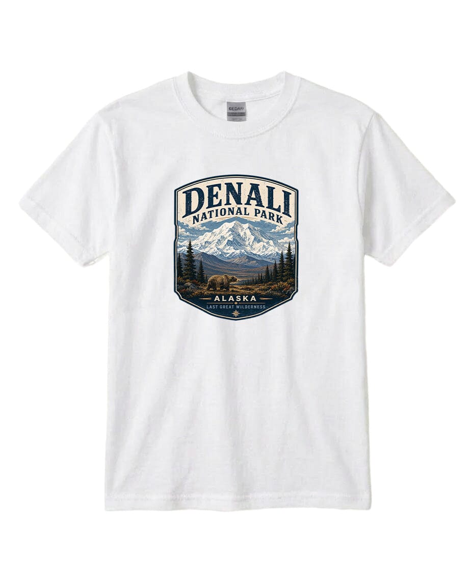 A white t-shirt with a graphic design featuring a mountain landscape and bears, along with the text "DENALI NATIONAL PARK ALASKA LAST GREATNESS".