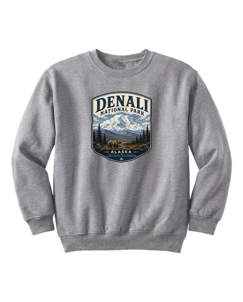 A gray sweatshirt with a graphic design featuring a mountain landscape and a bear.