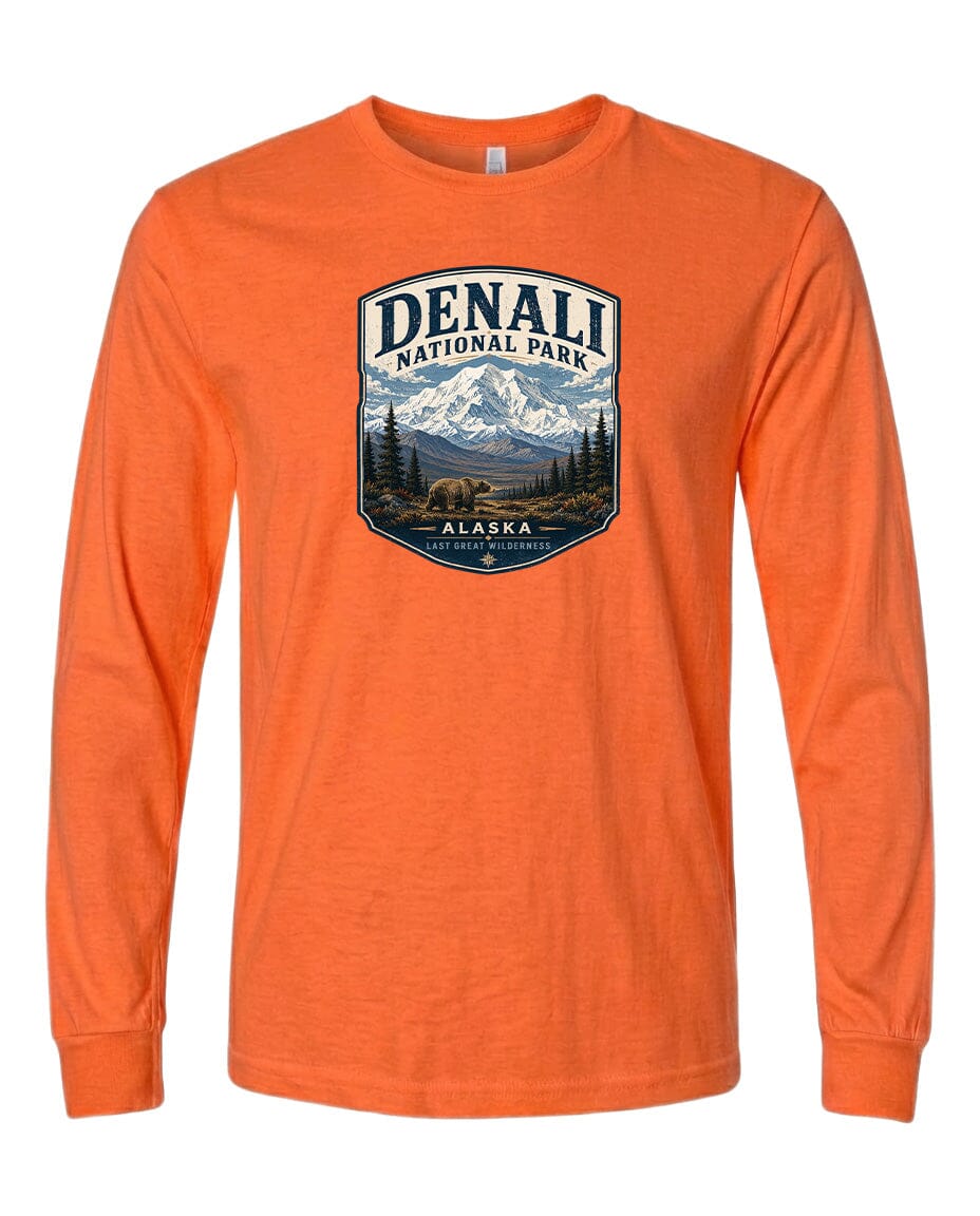 a long-sleeved orange t-shirt with a graphic design depicting a mountain range and a bear.
