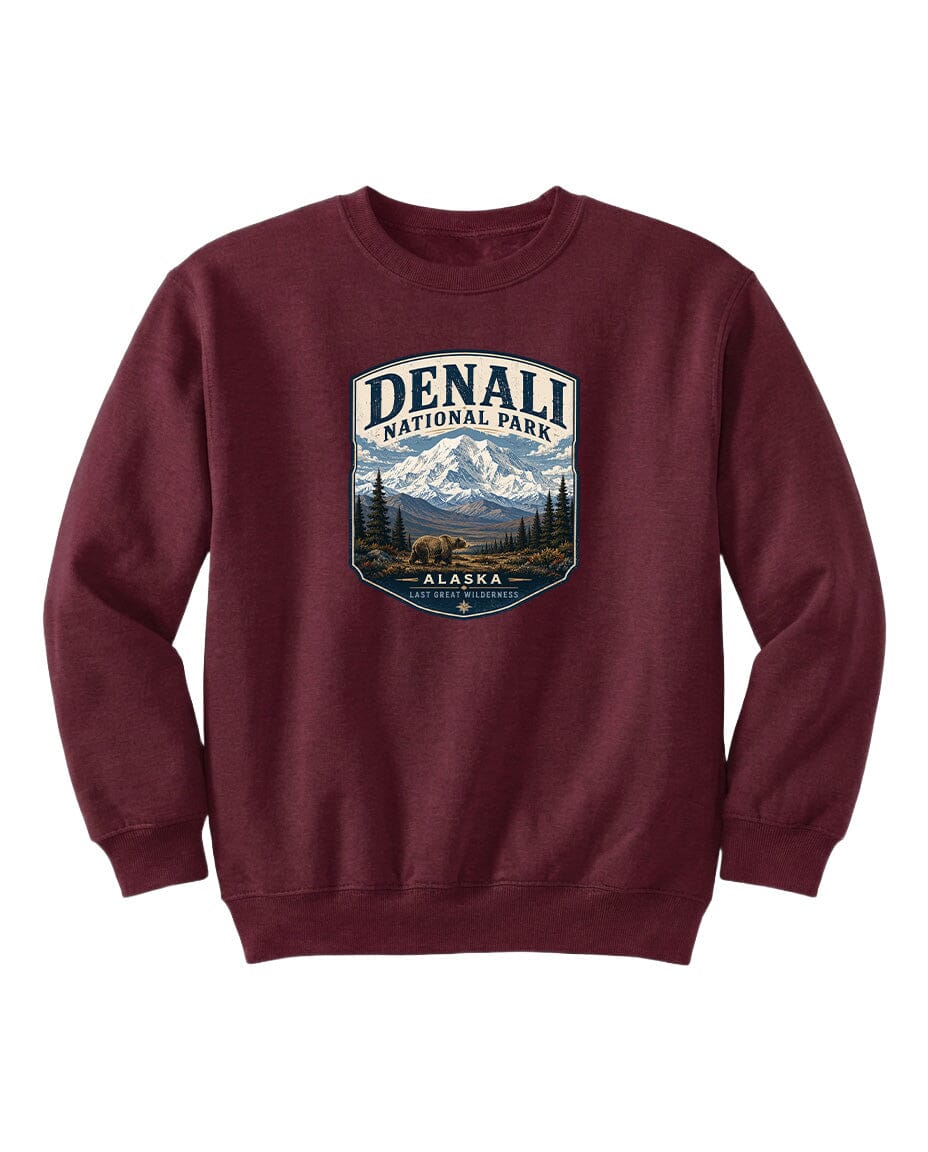A burgundy sweatshirt with a graphic design featuring a mountain landscape and bears, representing Denali National Park in Alaska.