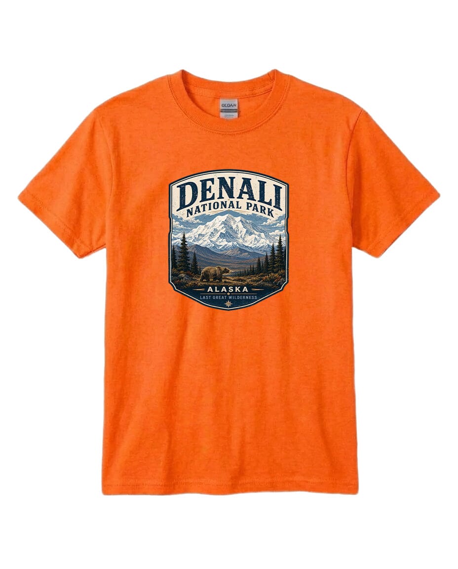 An orange t-shirt with a graphic design depicting a mountain landscape and bears, representing Denali National Park in Alaska.