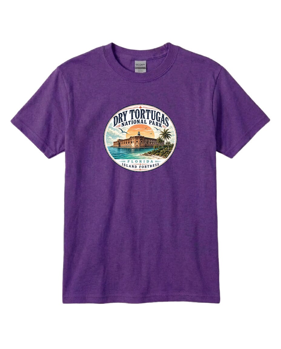 A purple t-shirt with a circular graphic design featuring a beach scene and a building, representing Dry Tortugas National Park in Florida.