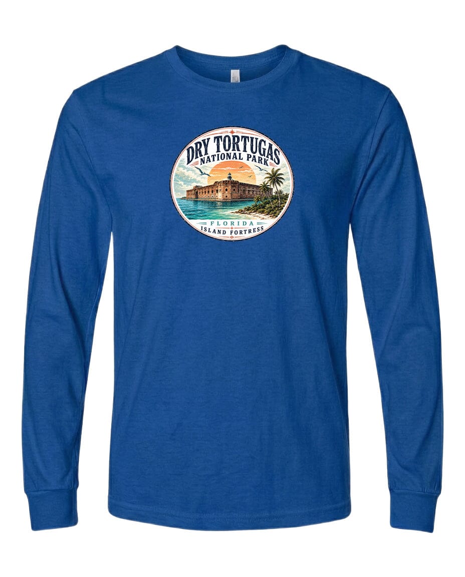A blue long-sleeved t-shirt with a circular design featuring a tropical island landscape and a building, likely representing Dry Tortugas National Park.