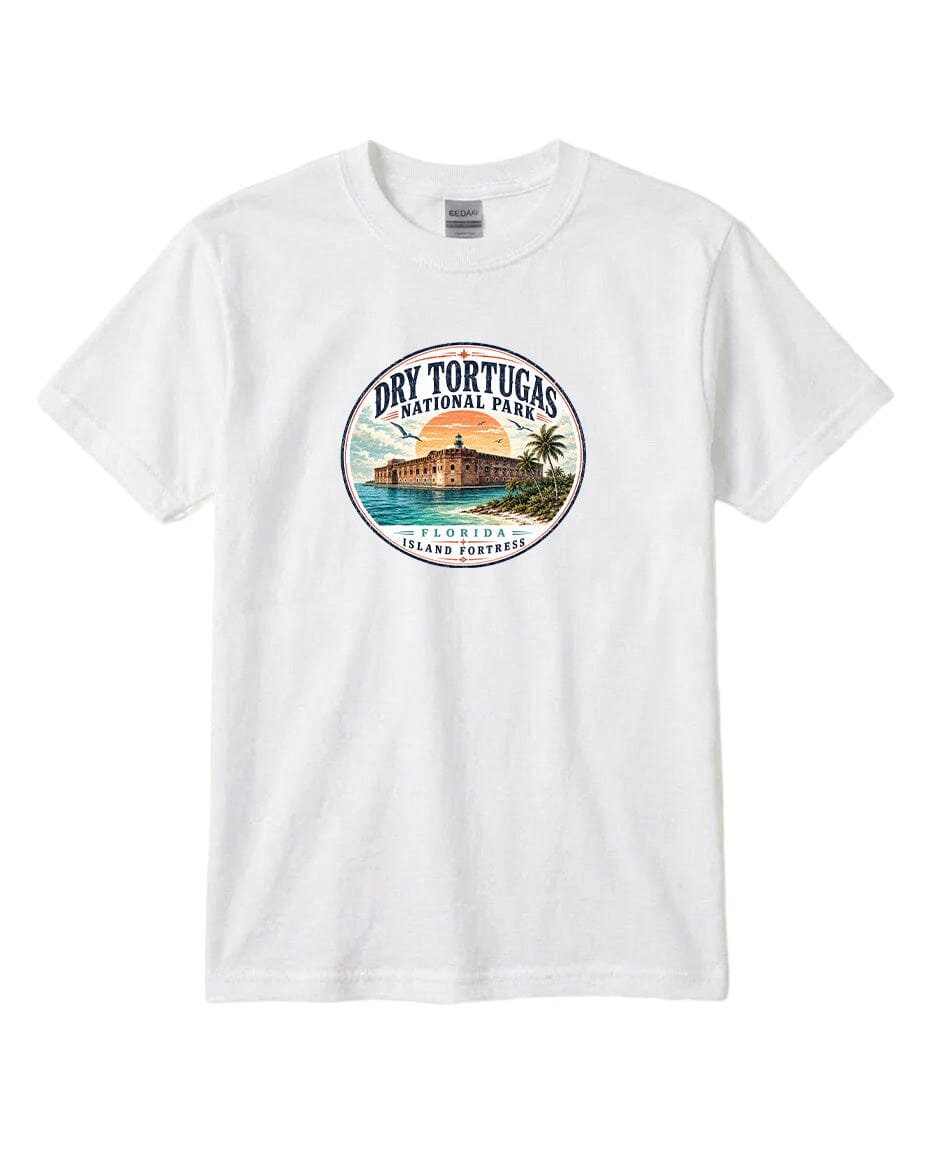 A white t-shirt with a circular graphic design featuring a tropical beach scene with palm trees, a building, and a sunset.