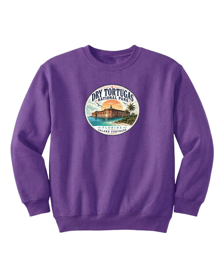 A purple sweatshirt with a circular graphic design featuring a beach scene and a building, representing Dry Tortugas National Park in Florida.