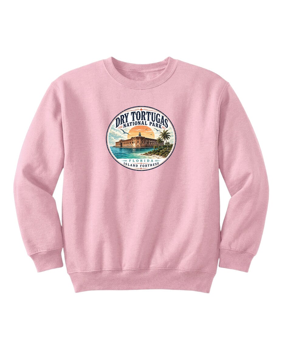 A pink sweatshirt with a circular graphic design featuring a beach scene and a building, likely representing Dry Tortugas National Park in Florida.
