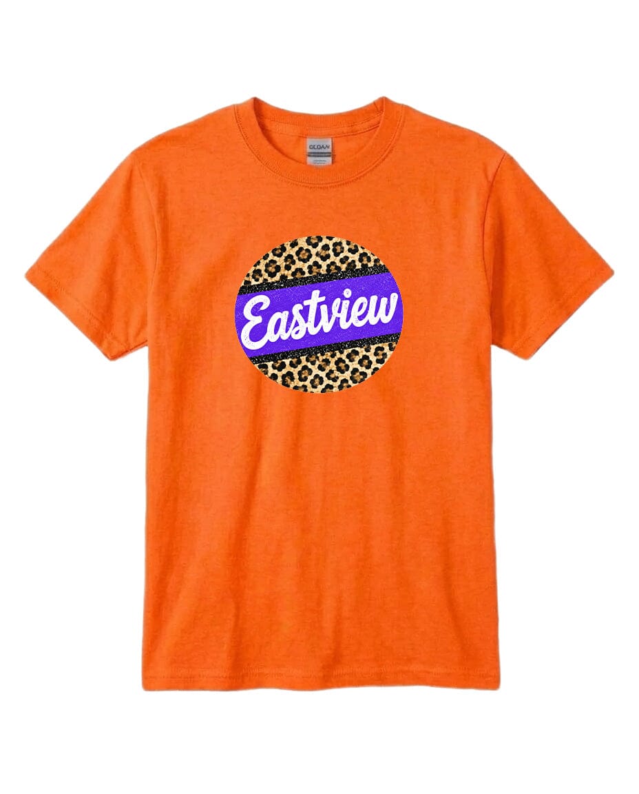 An orange t-shirt with a circular graphic design on it. The design consists of a leopard print pattern surrounding a blue and purple border, with the word "Eastview" written in white cursive letters.