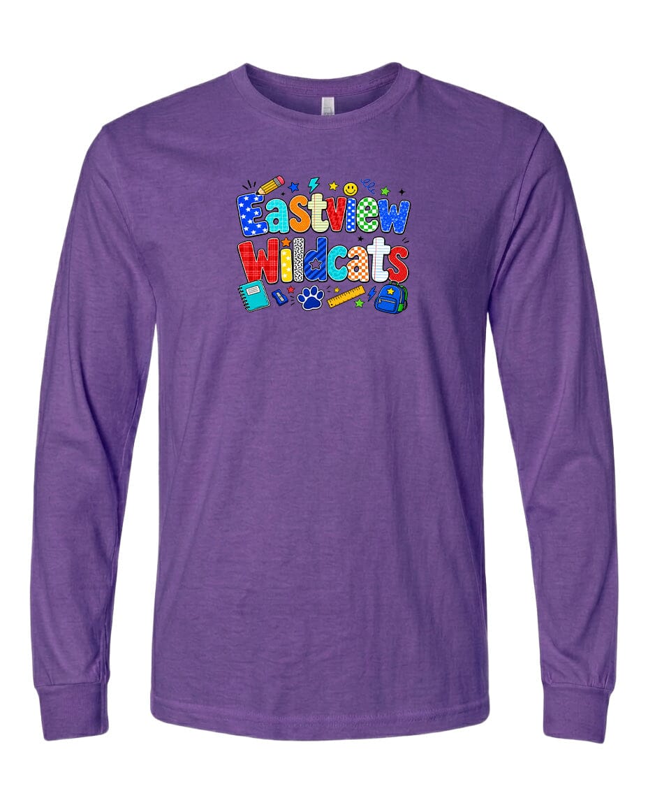 A purple long-sleeved t-shirt with a colorful graphic design featuring the text "Eastview Wildcats" and various school supplies such as pencils, books, and backpacks.