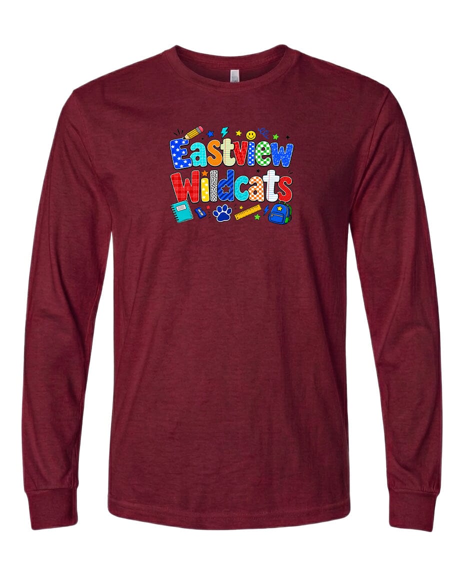 A burgundy long-sleeved t-shirt with a colorful graphic design featuring the text "Eastview Wildcats" and various school supplies such as pencils, books, and a backpack.