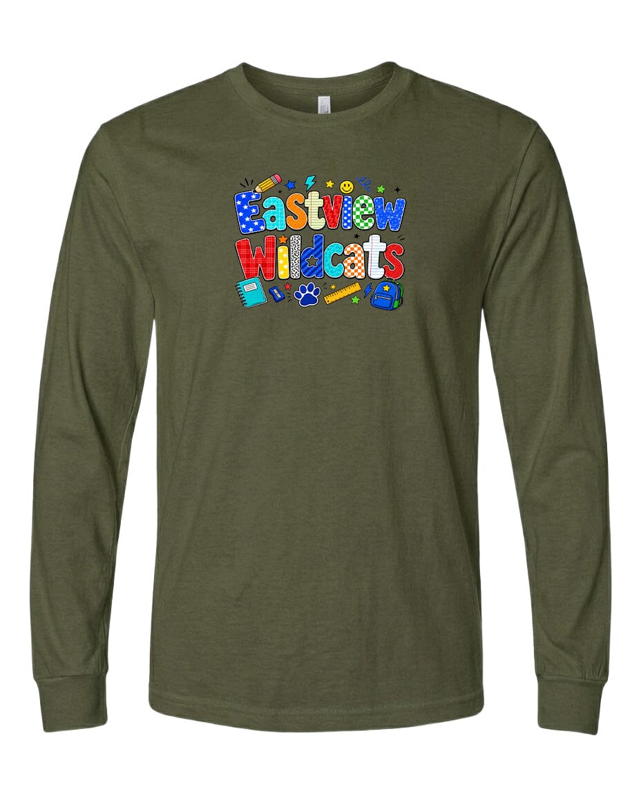 A long-sleeved olive green t-shirt with a colorful graphic design featuring the text "Eastview Wildcats" and various school supplies such as a pencil, eraser, and backpack.