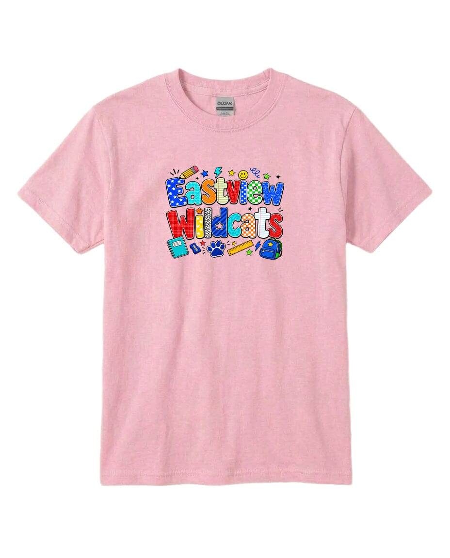 A pink t-shirt with a colorful graphic design featuring the text "Eastview Wildcats" and various school supplies such as pencils, backpacks, and a soccer ball.